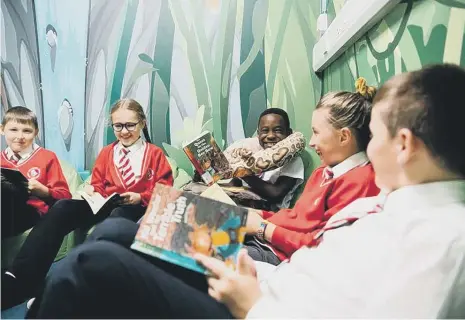  ?? ?? Children at Diamond Hall Junior Academy enjoying reading which Ofsted inspectors said had been “made a priority” at the school.