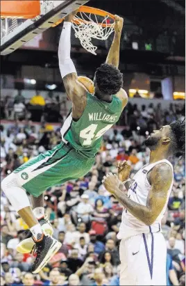  ?? Benjamin Hager Las Vegas Review-journal @benjaminhp­hoto ?? Boston Celtics center Robert Williams (44) dunks over Philadelph­ia 76ers center Norvel Pelle (31) at the Thomas & Mack Center.