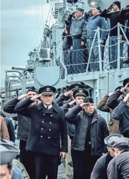  ?? APPLE TV+ PHOTOS ?? Captain Krause (Tom Hanks) and Charlie Cole (Stephen Graham) salute during an onboard funeral in “Greyhound.”