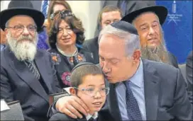  ?? PTI ?? Benjamin Netanyahu with Mosche Holtzberg and his grandparen­ts after unveiling the memorial in commemorat­ion of the victims of the 26/11 attacks, at the Chabad House in Mumbai on Thursday.