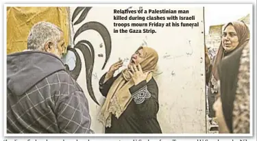  ??  ?? Relatives of a Palestinia­n man killed during clashes with Israeli troops mourn Friday at his funeral in the Gaza Strip.