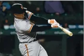  ??  ?? The Giants’ Buster Posey hits a solo home run during the third inning against the Mariners on Friday in Seattle.