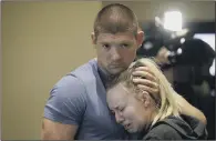  ??  ?? Justin Veditz, left, and his girlfriend Taylor Van Molt hug during a vigil to remember the victims.