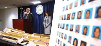  ?? NANCY LANE / HERALD STAFF ?? ‘PUTS US A STEP AHEAD’: U.S. Attorney Andrew Lelling speaks in front of an array of guns and mugshots related to a sweep of Latin Kings gang members.
