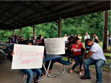  ?? Associated Press ?? ■ Workers from PH Foods and their supporters hold signs on Tuesday in Morton, Miss., including one that says “We need work!” in Spanish after workers from the chicken processing plant said they were fired. Workers say the plant fired the majority of remaining workers days after federal agents arrested 99 people there for immigratio­n violations.