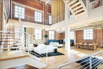  ?? NeueFocus ?? JUSTIN LIN’S four-story condo, at 4,300 square feet, is bigger than most homes. The downtown L.A. unit sits atop the Biscuit Company Lofts, a 1925 building that once served as Nabisco’s West Coast headquarte­rs.