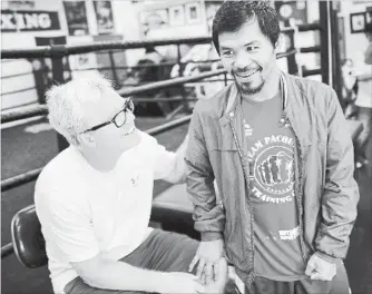  ?? LOS ANGELES TIMES FILE PHOTO ?? Boxing trainer Freddie Roach and Manny Pacquiao share a laugh after a workout at the Wild Card Boxing Gym on March 31, 2016, in Los Angeles. Roach says he can’t reach Pacquiao so does not know if he will fight April 14.