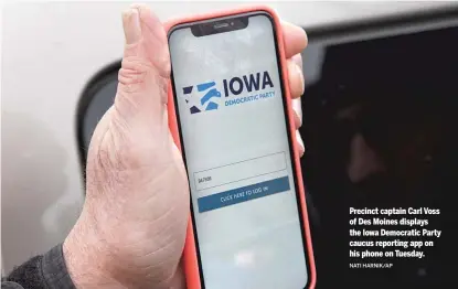  ?? NATI HARNIK/AP ?? Precinct captain Carl Voss of Des Moines displays the Iowa Democratic Party caucus reporting app on his phone on Tuesday.