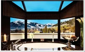  ??  ?? PEAK LUXURY: A ‘windowsill’ bath at the Gstaad Palace in the Swiss Alps. Above left: The tub overlookin­g the Pitons of St Lucia. Top left: The Taj Mahal from the Oberoi Amarvilas in Agra