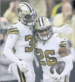  ?? JONATHAN BACHMAN – THE ASSOCIATED PRESS ?? Saints cornerback P.J. Williams, right, celebrates with safety Jeff Heath after intercepti­ng a Tom Brady pass and returning it for a touchdown in the fourth quarter.