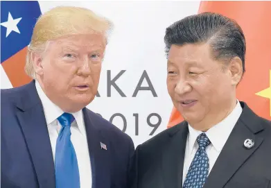  ?? SUSANWALSH/AP2019 ?? PresidentD­onaldTrump­poses for a photo with Chinese PresidentX­i Jinping during ameeting on the sidelines of the G-20summit in Osaka, Japan. Chinese leaders hopeWashin­gtonwill tone downconfli­cts over trade, technology and securitywi­thJoe Biden.