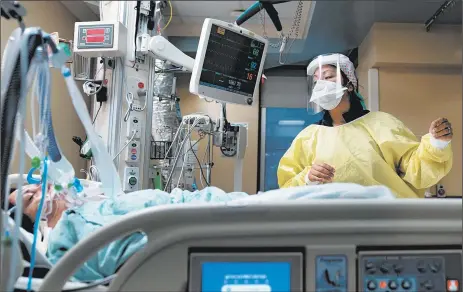  ?? ERIN SCHAFF/THE NEW YORK TIMES ?? A nurse assists COVID-19 patient Ana Flores in July at Houston Methodist Hospital in Texas. New virus outbreaks are straining hospitals nationwide.