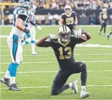 ??  ?? Saints wide receiver Michael Thomas celebrates Sunday after catching a pass that gained a first down.