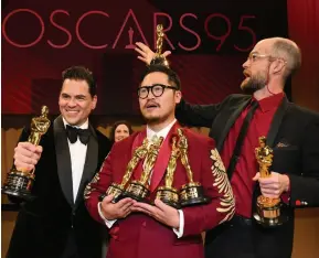  ?? ?? From left: Everything Everywhere All at Once producer Jonathan Wang and directors Daniel Kwan and Daniel Scheinert showed off the film’s seven Oscars.