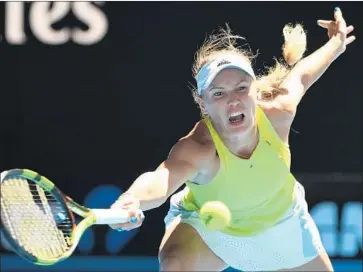  ?? Williams West AFP/Getty Images ?? FORMER NO. 1 Caroline Wozniacki won 24 of 31 points after facing her first match point against Jana Fett.