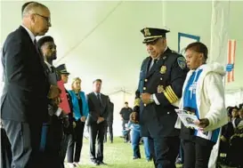  ?? STAFF ?? The mother of Baltimore City Police Officer Keona Holley is escorted up to accept a plaque in honor of her daughter during the Fallen Heroes Day ceremony at Dulaney Valley Memorial Gardens on May 6, 2022.