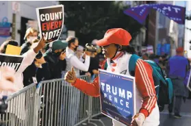  ?? Matt Slocum / Associated Press ?? Supporters of both President Trump and former Vice President Joe Biden demonstrat­e outside the Philadelph­ia center where votes are being counted.