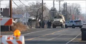  ?? ?? The Associated Press
A SWAT MRAP vehicle is parked near the site of a triple fatal shooting in Yakima, Wash., on Tuesday.