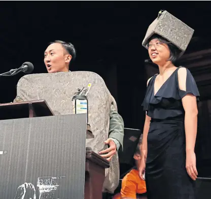  ??  ?? David Hu and Patricia Yang receive an award for studying how and why wombats make cubed poo. Pictures: AP.