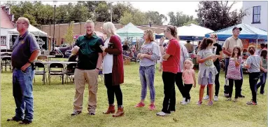  ?? RITA GREENE/MCDONALD COUNTY PRESS ?? Lining up to get the bowls for the chili as the chili cookoff begins at the Oktoberfes­t Saturday at Pineville Square.