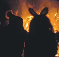  ??  ?? A rather large rabbit and its bobble-hatted pal gather round Clachan’s bonfire. 25_c45clachan­bonfire05