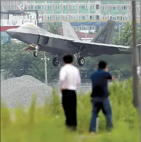  ?? AP/Yonhap/PARK CHUL-HONG ?? A U.S. F-22 stealth fighter lands Wednesday at an air base in Gwangju, South Korea, during U.S.-South Korean military exercises that North Korea’s news agency called “an intended military provocatio­n.”