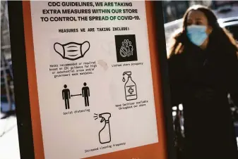  ?? John Minchillo / Associated Press ?? A sign in New York City advises of coronaviru­s precaution­s in March. The White House is asking Congress for additional funding to fight the wider spread of the coronaviru­s.