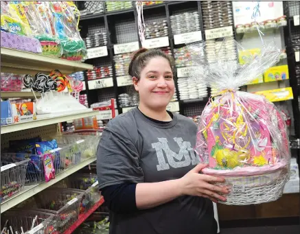  ?? Ernest A. Brown/The Call ?? Kayla Lavoie, of Woonsocket, a longtime store clerk at Pearl’s Candy and Nuts in Park Square, was busy selling Easter Baskets for Easter Sunday in the store on a busy Saturday. The store was jam-packed with customers looking for the perfect Easter treats.