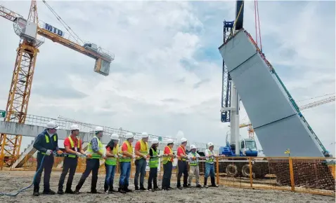  ?? — Contribute­d Photo ?? REBIRTH OF PHILIPPINE SPORTS. Philippine Sea Games Organizing Committee (PHISGOC) Chairman Alan Peter Cayetano led the installati­on of composite columns at the New Clark City Athletic Stadium during the committee’s site visit on Saturday, July 7. The Athletic Stadium is part of the world-class sports facilities being built by AlloyMTD and the Bases Conversion and Developmen­t Authority (BCDA) for the country’s hosting of the 2019 Southeast Asian Games. Clark will serve as the main hub of the 2019 SEA Games with the Aquatics and Athletics event to be held at the New Clark City.