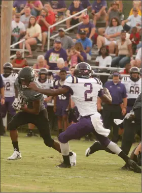  ?? Terrance Armstard/News-Times ?? Breaking free: Smackover running back Dexter Crockett tries to run past Junction City's Jamie Carroll during their contest at Smackover earlier this season. On Friday, Smackover hosts Fouke in 5-3A play, while the Dragons host Bearden after having a bye week. Both schools are hosting homecoming this week.