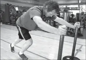  ?? Dallas Morning NEWS/LARA SOLT ?? Glenn Gehan pushes weights during his twice-a-week, one-hour workout with a trainer at Cooper Fitness Center in Dallas.