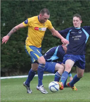  ??  ?? Andy Moore of North End United is challenged by Ryan Harris of Campile United.