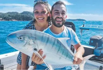  ?? ?? Agabi and Bishoy Saaman were happy to release this golden trevally on a fishing charter.