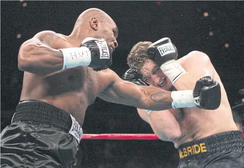  ?? AFP ?? Former heavyweigh­t champion Mike Tyson, left, fights Kevin McBride in 2005.