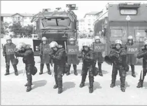  ??  ?? Malaysia’s public order police, the Federal Reserve Unit (FRU), pose for a photo at their headquarte­rs in Kuala Lumpur. (Photo: Reuters)