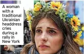  ?? ?? A woman with a traditiona­l Ukrainian headdress cries during a rally in New York
