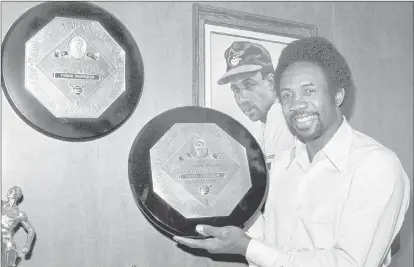  ?? Harold Filan The Associated Press file ?? Frank Robinson, MLB’S first African-american manager, shows off his two MVP awards in a photograph from Dec. 3, 1971.
