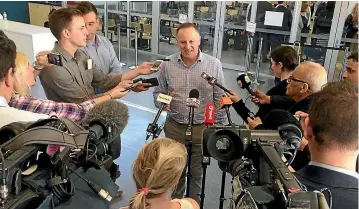 ?? PHOTO: FAIRFAX NZ ?? John Key speaks to reporters at Townsville Airport, where he was delayed overnight on his way to India.