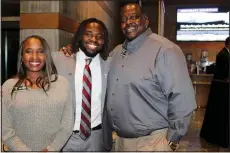  ?? (NWA Democrat-Gazette/Carin Schoppmeye­r) ?? Carlton Martial, Burlsworth Trophy finalist, is joined by his parents Elizabeth and Philbert Martial at the announceme­nt ceremony Dec. 5.