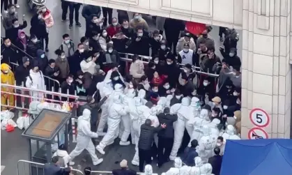  ?? ?? Shanghai residents scuffle with staff dressed in protective clothing on Wednesday, in an image obtained from social media. Photograph: Reuters