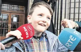  ?? PHOTO: COLLINS COURTS ?? Amazing strides: Proud Iarlaith Ó Cinnéide speaks to the media on leaving the Four Courts.