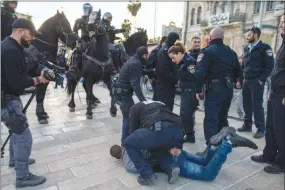  ?? URIEL SINAI / THE NEW YORK TIMES ?? Israeli police arrest a protester Dec. 7 as Palestinia­ns demonstrat­e at the Damascus Gate outside the Old City of Jerusalem. Widespread prediction­s of unrest were realized in the region a day after President Donald Trump took the high-risk move of...