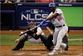  ?? ASSOCIATED PRESS ?? LOS ANGELES DODGERS’ YASIEL PUIG Saturday’s game in Milwaukee. hits a three -run home run during the sixth inning of