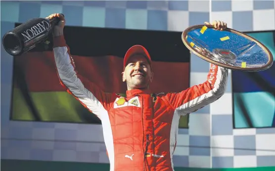  ?? INSPIRING VICTORY: Sebastian Vettel and Ferrari are celebratin­g after their win in the Australian Formula One Grand Prix. Picture: CLIVE MASON/ GETTY IMAGES ??
