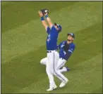  ?? The Associated Press ?? STRETCH: Toronto Blue Jays second baseman Joe Panik, front, makes a catch for the out on a fly ball by Washington Nationals’ Adam Eaton during the fourth inning of Thursday’s game in Washington. At right is Blue Jays’ Cavan Biggio.