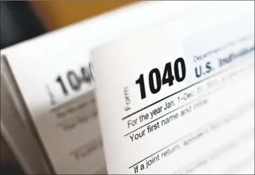  ?? Daniel Acker Bloomberg ?? TAX PREPARERS are bracing for the 2020 filing season, which runs Jan. 27 to April 15. The IRS is still catching up on tax code changes made more than two years ago, and Congress passed tax breaks late last year.