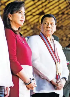  ??  ?? RARE MOMENT TOGETHER – President Duterte casts a glance at Vice President Leni Robredo during the graduation ceremonies of the Philippine Military Academy (PMA) in Baguio City last Sunday. The two are seldom seen in public together. (Office of the Vice...