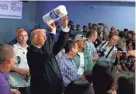  ?? AP ?? President Donald Trump tosses paper towels into a crowd at Calvary Chapel in Guaynabo, Puerto Rico.