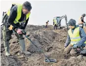  ??  ?? Amateur archaeolog­ist Rene Schoen and 13-year-old student Luca Malaschnit­schenko, left, at the dig site, right, were braided necklaces, pearls, brooches, a Thor’s hammer, rings and up to 600 chipped coins were found