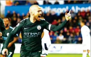  ?? GEOFF CADDICK/AFP ?? Manchester City midfielder David Silva celebrates after scoring his side’s third in their English Premier League match against Swansea City on Wednesday.